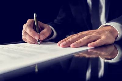 Man Signing Documents