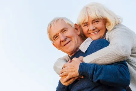 Elderly Woman Hugging Man