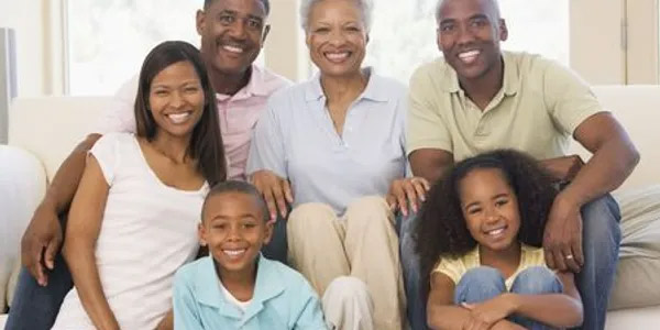 Family with Grandparents Smiling on Couch