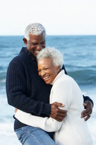 Man Holding Woman at Beach